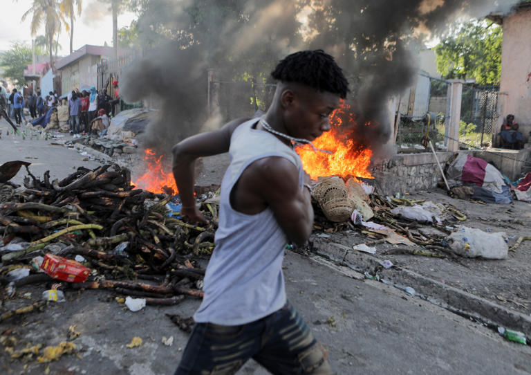 Riot police clash with protestors in Haiti over fuel shortages & rising prices