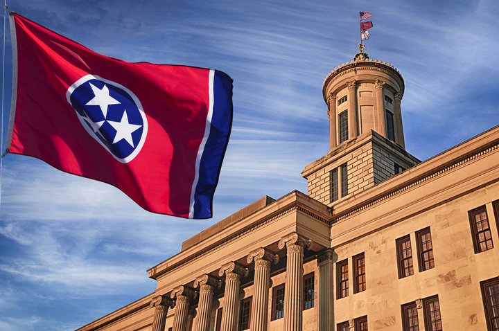 State capitol building in nashville tennessee with us state flags outside